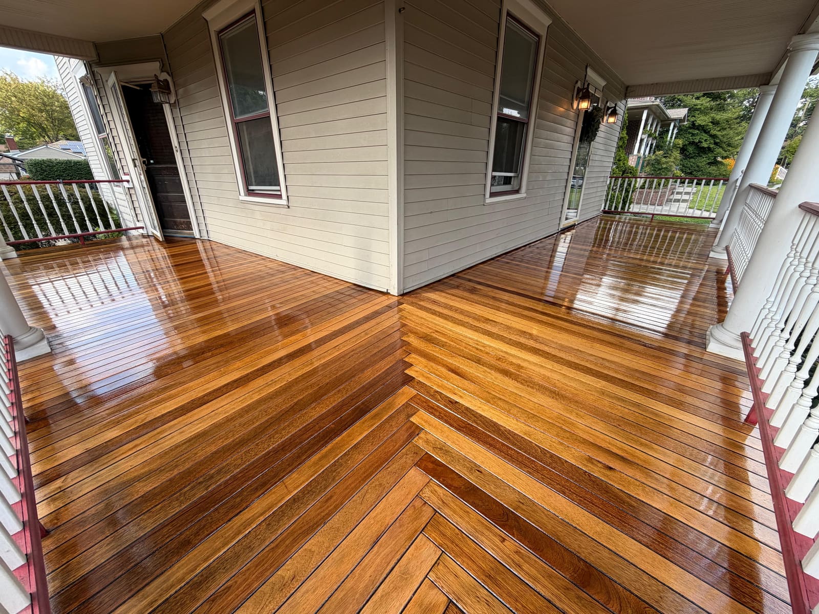 Restored Victorian porch with glossy stained herringbone wood decking in Cherry Hill, NJ.
