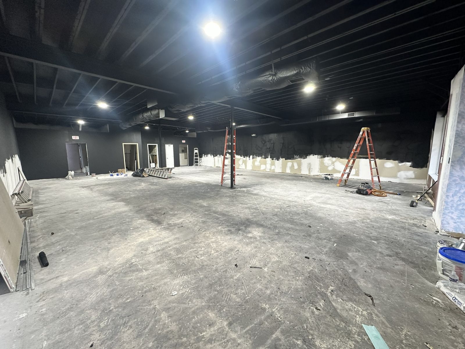 Exposed ceiling deck and structural steel sprayed black, walls painted, at an MMA gym in Haddonfield, NJ
