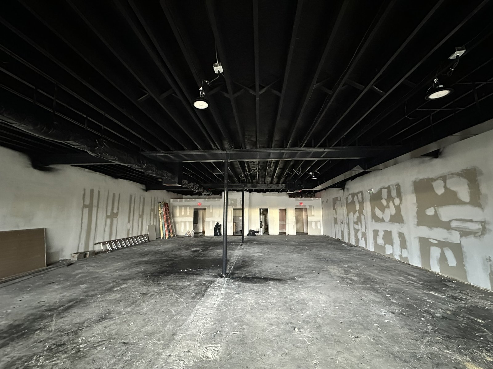 Unpainted exposed ceiling deck and drywall walls before commercial painting at an MMA gym in Haddonfield, NJ