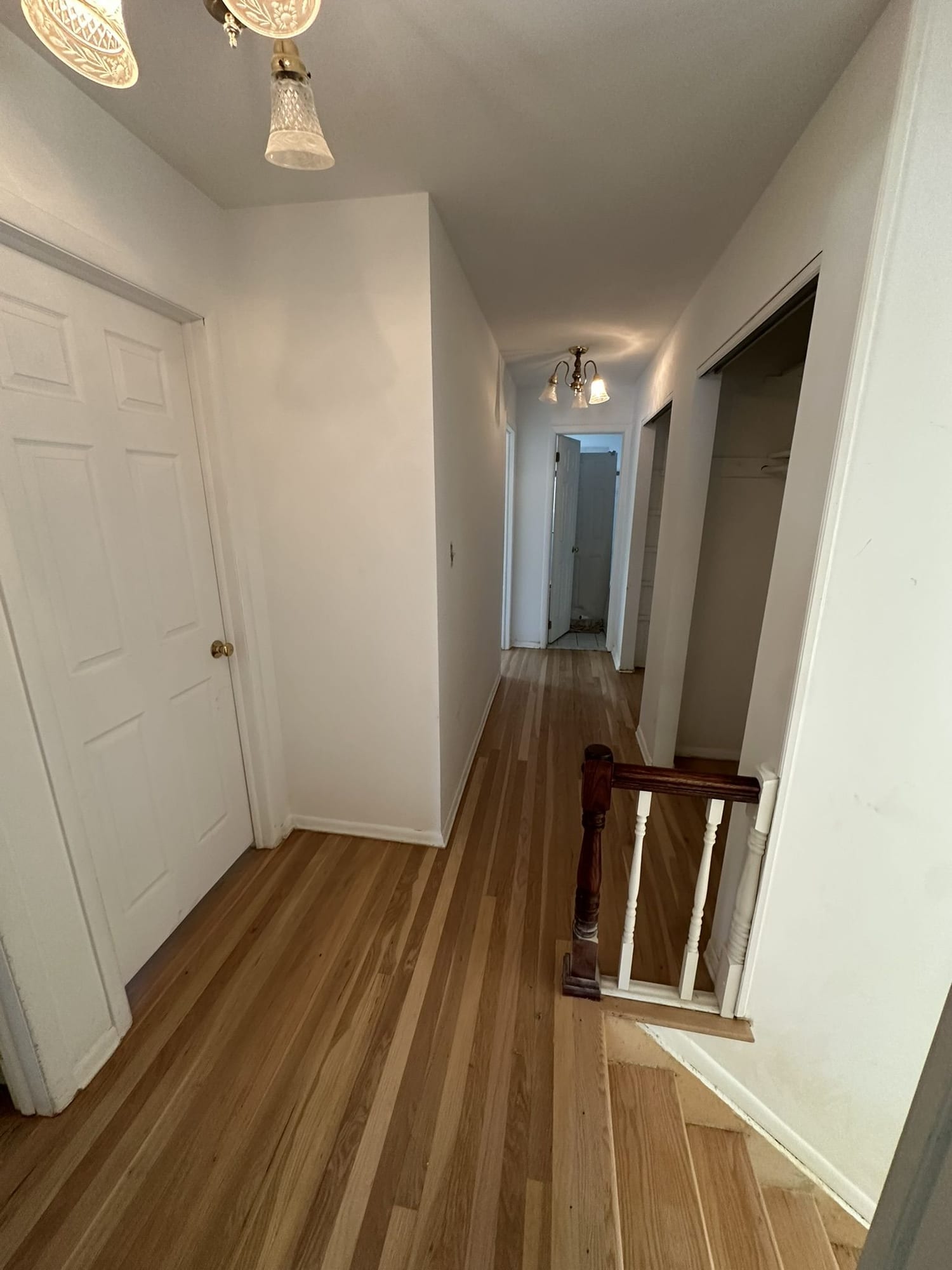 Hallway and staircase after skim coating, drywall repair, and repainting in Moorestown, NJ.
