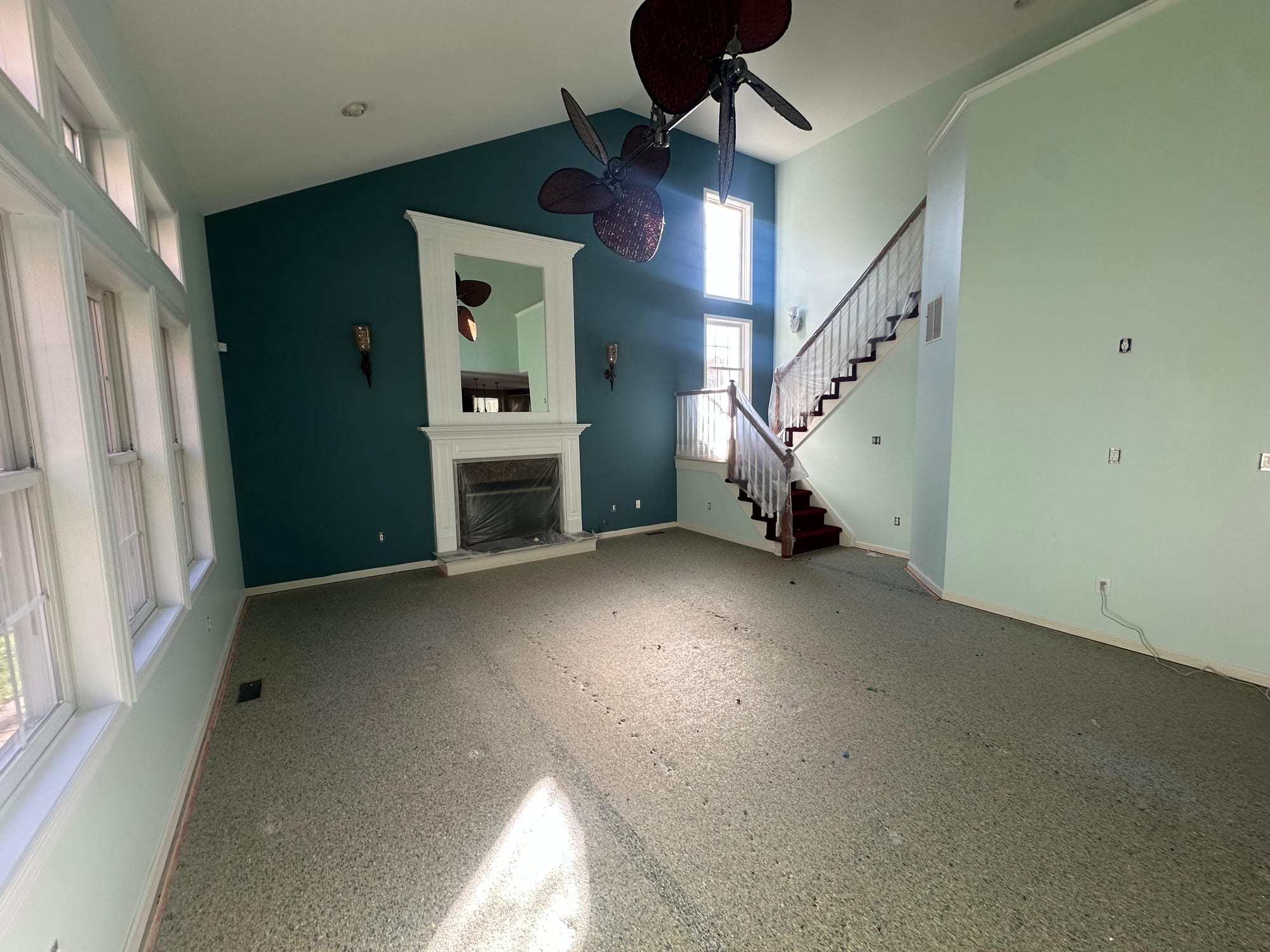 Living room after a full interior repaint with a dark teal accent wall in Mount Holly, NJ.